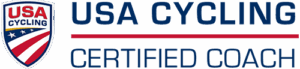USA Cycling Certified Coach logo featuring a shield with stars and stripes on the left, bold blue text reading USA Cycling Certified Coach.