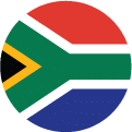 A circular flag icon of the South African flag, featuring green, yellow, black, white, red, and blue colors in a unique geometric design.